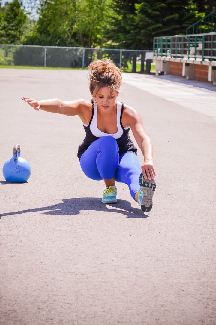 Woman squatting with leg extended