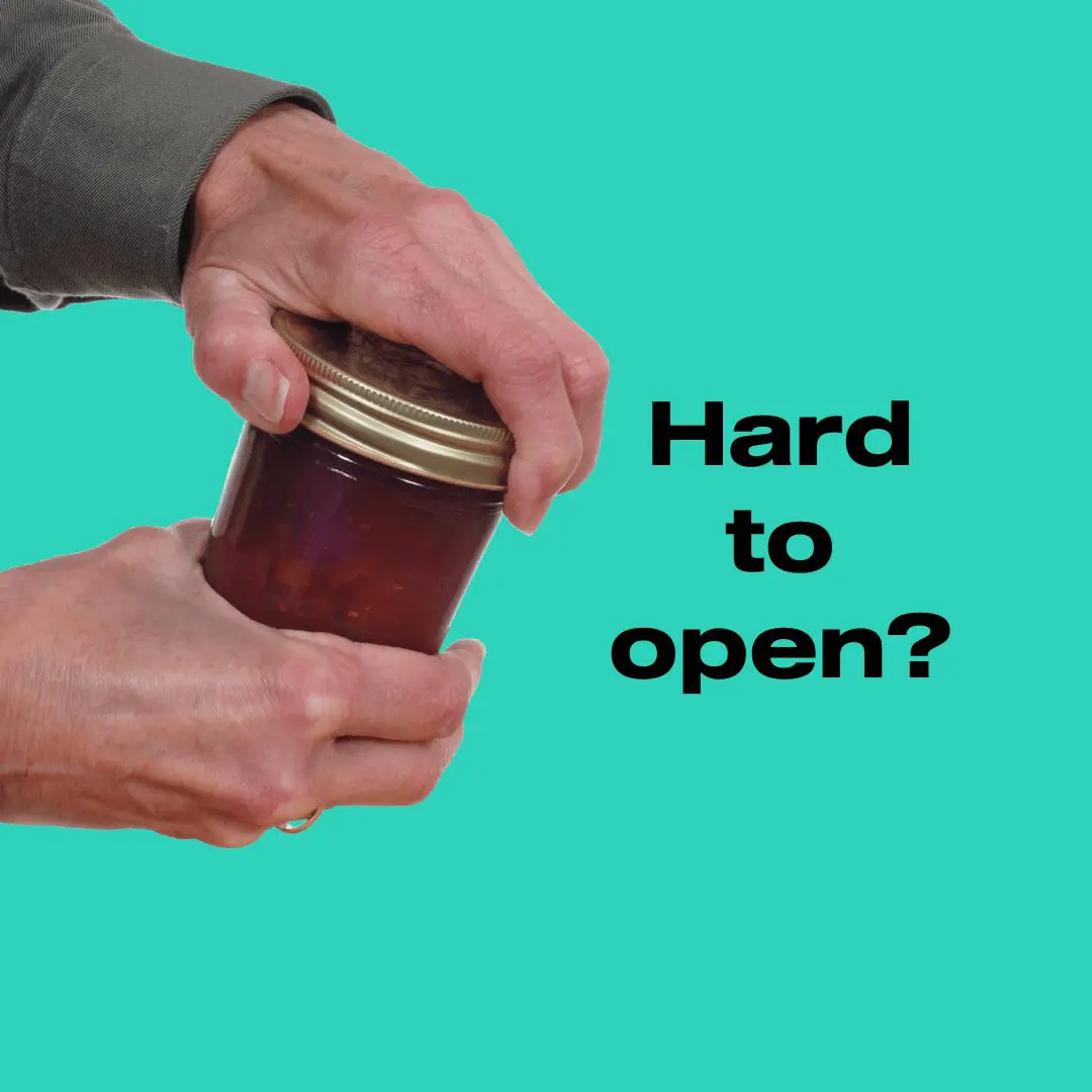 a man opening a jar of jam with both hands