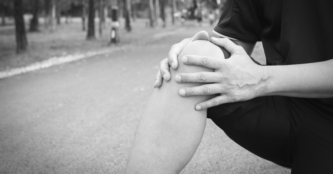 a person holding their knee