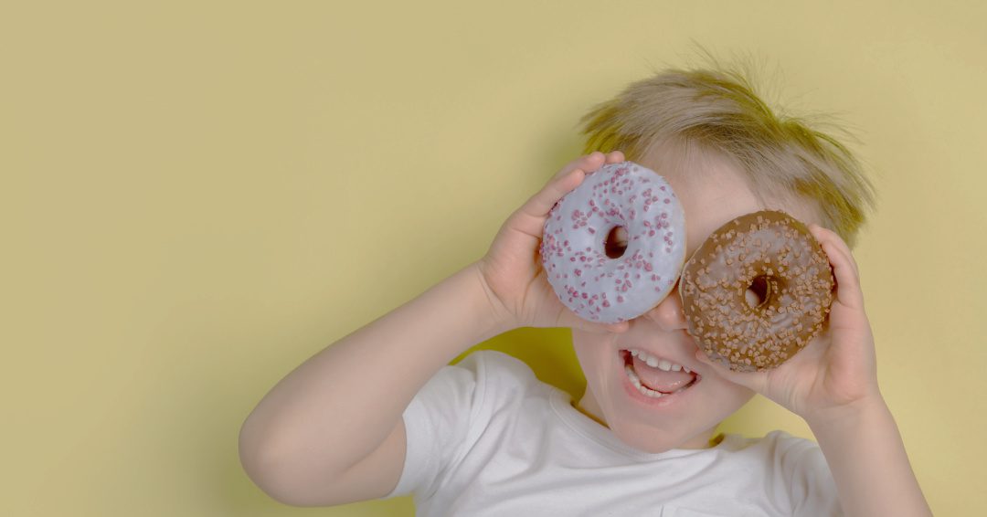 Child with Doughnuts Over His Eyes