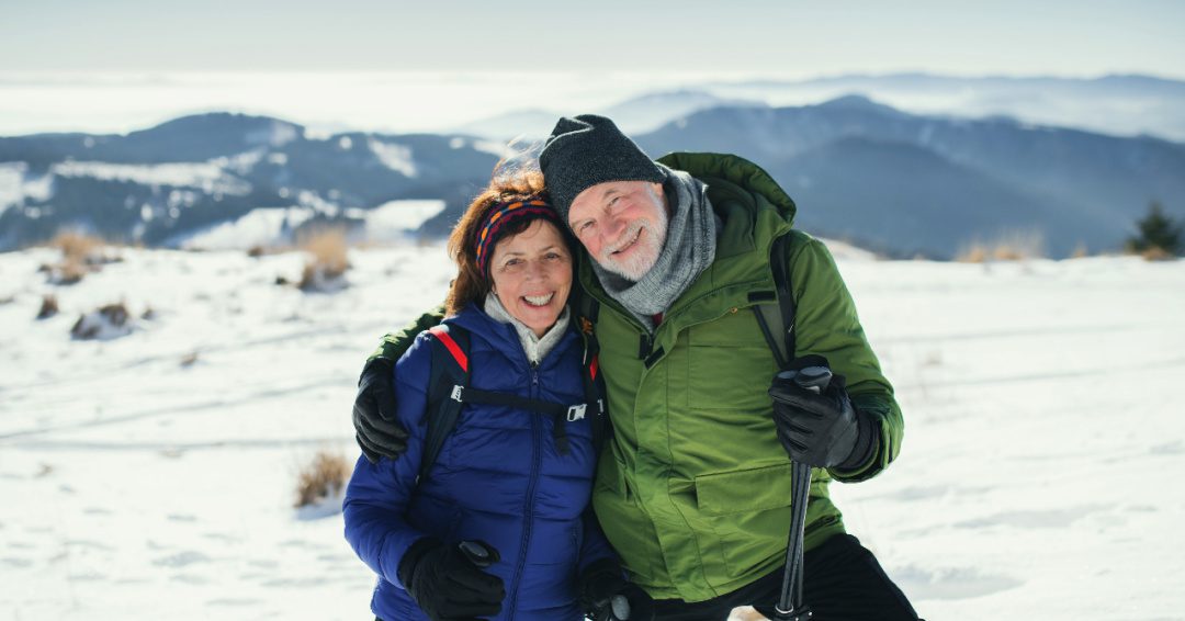 2 older people walking in the snow